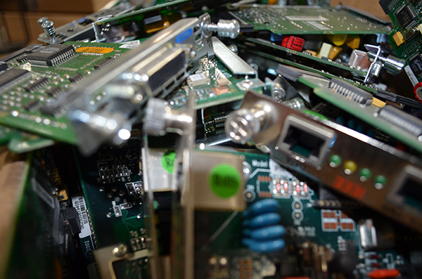 Many computer chips from radios in a messy pile.