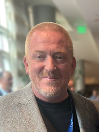 Patrick Ferry in business attire at a Takeback Programs event, reflecting e-waste services focus.