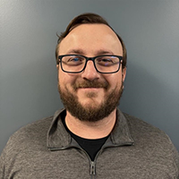 A Dynamic Lifecycle Innovations Operations Team member smiles, representing their focus on electronics recycling and IT asset disposition.